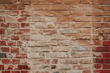 The texture of an old brick wall with natural defects. Scratches, cracks, crevices, chips, dust, roughness, abrasion. Template for design and background.Copy space