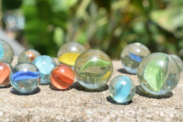 Colorful Playing Glass Balls. Glass blue ball. Abstract photo with Marble ball and reflection. Selective focus