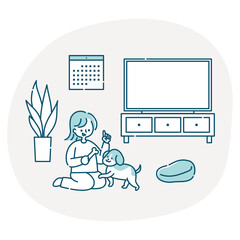 リビングで犬と一緒に遊ぶ女性