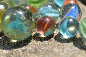 Colorful Playing Glass Balls. Glass blue ball. Abstract photo with Marble ball and reflection. Selective focus