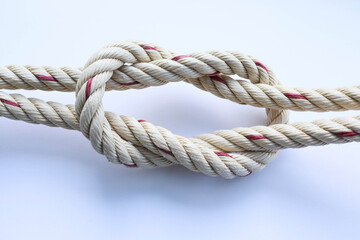 Nylon marine ropes tied to knot isolated on white background closeup.