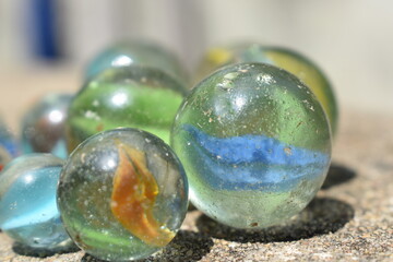 Colorful Playing Glass Balls. Glass blue ball. Abstract photo with Marble ball and reflection. Selective focus