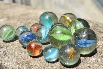 Colorful Playing Glass Balls. Glass blue ball. Abstract photo with Marble ball and reflection. Selective focus