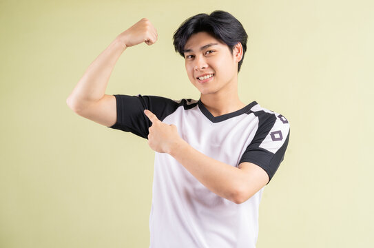 The Asian Man Is Showing Off His Muscles