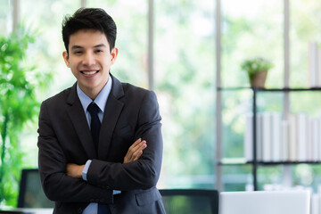 Positive Asian businessman in office