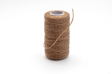 Spool of waxed brown sewing threads