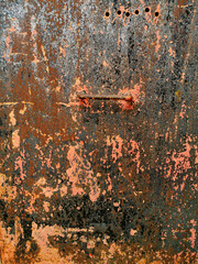 texture old black and pink painted metal plate nailed rusting and crumbling