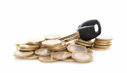 A pile of euro coins on a white background and the key to wealth