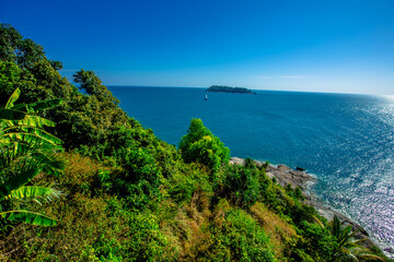 Fototapeta premium The natural background of the morning light rising in the middle of the sea and surrounded by mountains, cool breezes, the beauty of the ecology of the tourist attractions.