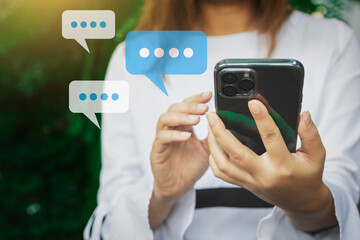 women's hand typing with balloon chat on smartphone, Live Chat Chatting on application Communication Digital Web and social network Concept.