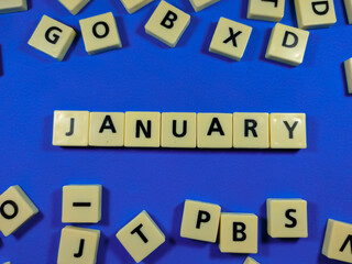 Obraz premium Alphabets on blue background with text JANUARY.