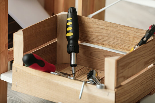 Box with different construction tools in workshop, closeup