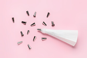Pastry bag and different tips on color background