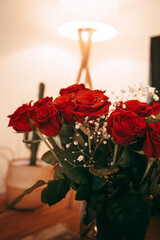 Red roses with white flowers in a vase - home decoration