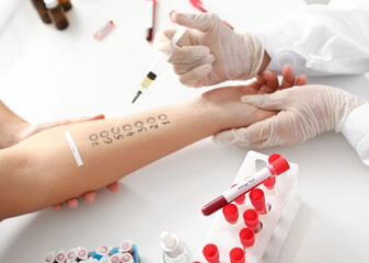 Young woman undergoing procedure of allergen skin tests in clinic