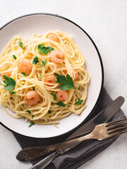 Spaghetti shrimp scampi in plate vertical shot