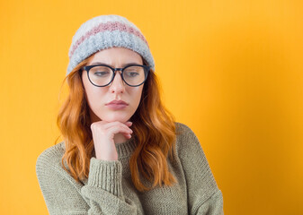 Closeup depressed young women, isolated on yellow background. Depressed lonely girl