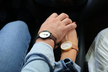 Young couple holding hands in car