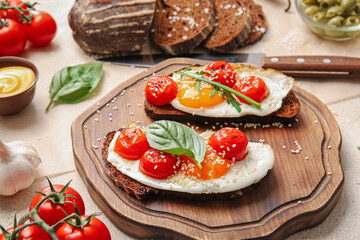 Wooden board with fresh tasty bruschettas on light background
