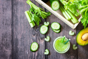 Vegan diet and nutrition, healthy detox, vegetarian concepts drinks. Green smoothie celery, avocado, cucumber and spinach on a rustic table. Top view flat lay. Copy space.