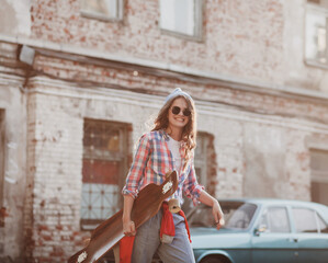 active woman in a plaid shirt with a skateboard