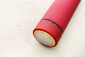 Modern thermos on light background, closeup