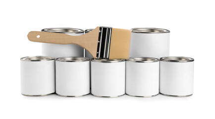 Cans of paint and brush on white background