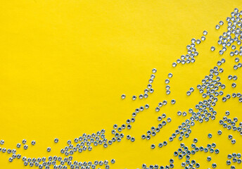 rhinestones on a yellow background, top photo. design for text