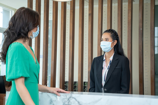 Receptionist wearing mask to protect from coronavirus covid 19 are talking customers who come to stay at the hotel.