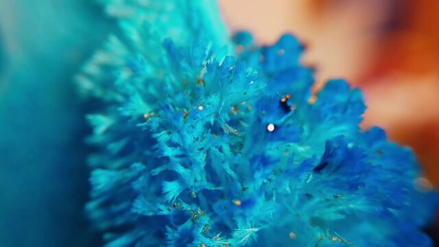 Macro of rotating pile of blue salt crystals. Abstract background of the movement of shining blue crystal particles