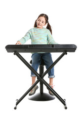 Little girl playing synthesizer on white background