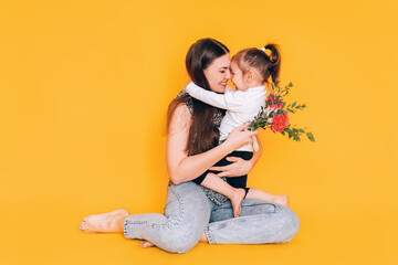 Daughter gives gift to her mother. Congratulations to the parents on the holiday