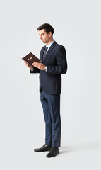 Obraz na płótnie Canvas Male lawyer with book on grey background