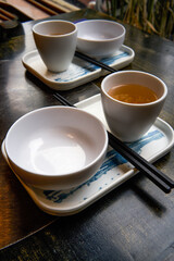 Two sets of Chinese-style tableware on the dining table, rice bowl, chopsticks and teacup