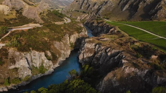 Aerial above canyon reveal nice scenery of vineyard field and rocky mountains. New Zealand