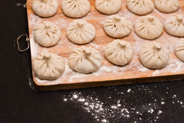 Slender rows of uncooked Georgian khinkali