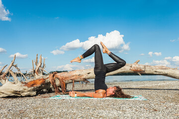 healthy lifestyle young woman practice yoga at river beach at fresh air sunny summer day inverted...