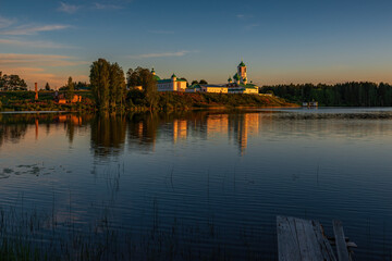 The monastery is located in a picturesque place on the high shore of the Roshchinsky lake, clear...