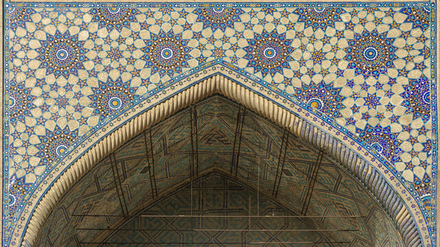 Beautiful floral and geometric mosaic above entrance of ancient Ulugh Beg madrassa in UNESCO listed Samarkand, Uzbekistan