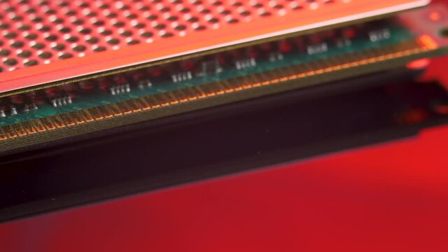 Module DDR RAM sticks on red light mirror background. Computer memory with contact pins. Heat spreader. Random Access Memory abbreviated as SDRAM