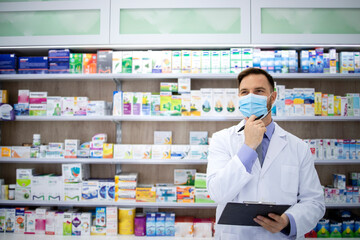 Pharmacist selling medicines in pharmacy shop during corona virus pandemic. Healthcare and medicine.