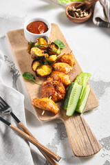 Chicken Thigh Kebabs With Roasted Potatoes. Grilled chicken skewer on white table. Restaurant rustic food concept.