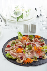 Sliced Beef or Pork with Marinated Vegetables and Sauce. Beautifully decorated catering banquet menu. Food snacks and appetizers for buffet on white background