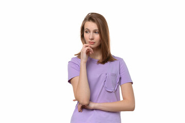 Portrait of cute thinking young woman holding arm on chin wear casual t shirt