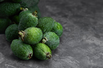 Feijoa whole on black background. Exotic fruit. Selective focus. Closeup.