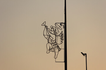 The figure of an angel on an electric pole