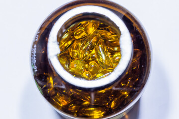 Vitamins in capsules in a jar close up