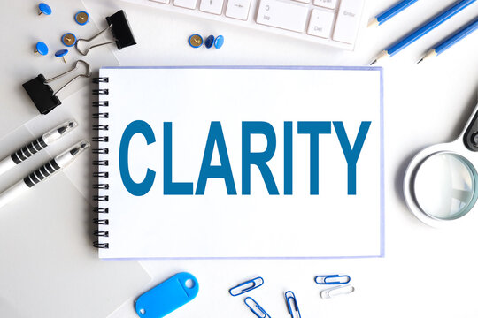 clarity. Text on white notepad paper on light background