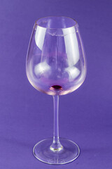 Empty dirty wine glass on a blue background.