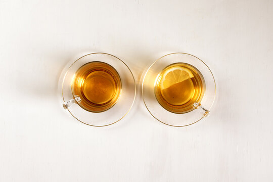 Two Cups Of Green Tea On White Background, View From Above